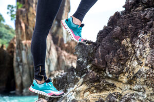 The girl in sportswear on the rocks , the concept of sports activity
